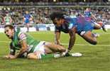 Phil Graham dives over, despite Milton Thaiday's best efforts.