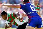 Roy Asotasi ducks under Daniel Abraham's tackle.
