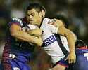 Karmichael Hunt is taken down by Newcastle defenders.