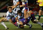 Todd Polglase is barrelled into the EnergyAustralia Stadium ground.