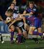 Michael Luck is tackled from all directions by Newcastle.