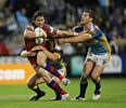 Kurt Gidley puts a fend on and charges forward.