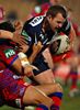 Useless Clint Newton is tackled (holding onto the ball for once in his life).
