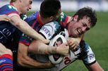 Luke Walsh and George Carmont pull down Trent Waterhouse.