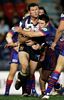 Ray Cashmere is tackled by Danny Buderus.