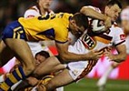 Ben Cross is tackled in an exceptionally small photo.