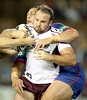 Glenn Stewart is tackled by Jesse Royal.