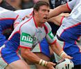 Richard Fa'aoso is driven backwards by a Warrior.